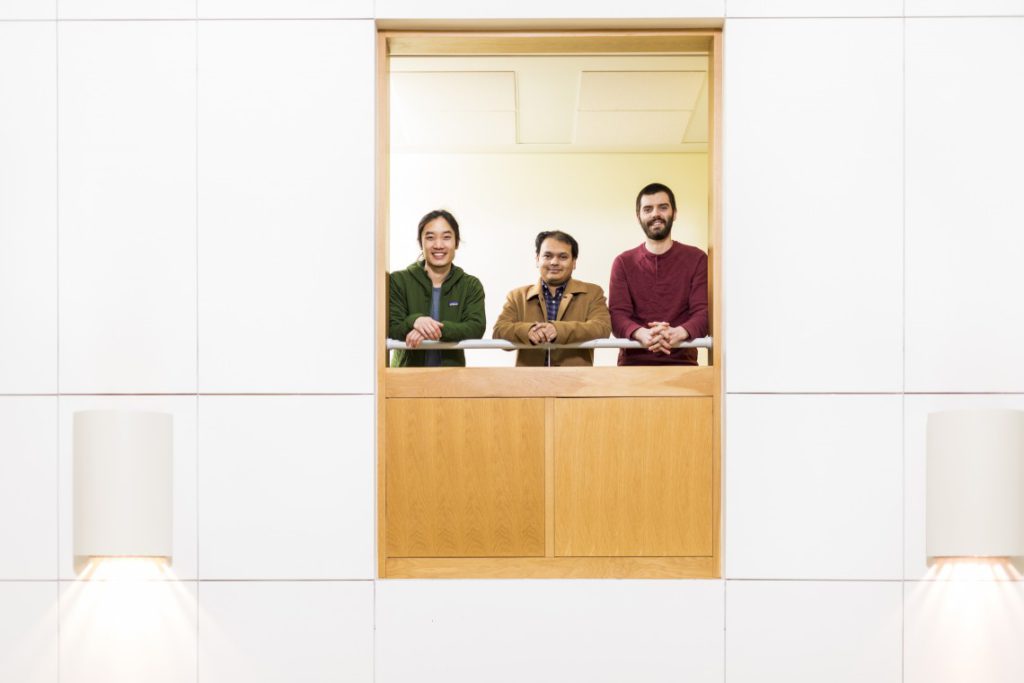 Arka Majumdar (center) and graduate students Alan Zhan (left) and Shane Colburn (right)