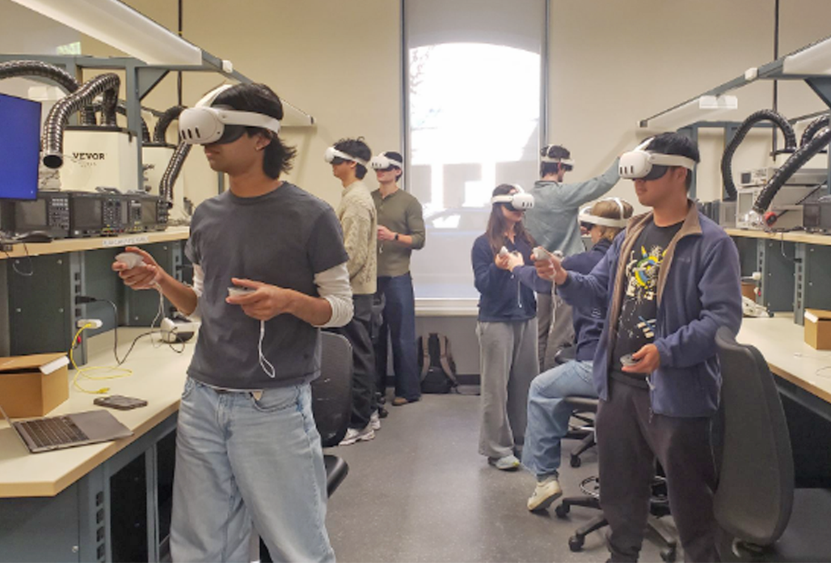 Students standing in lab wearing virtual reality headsets and holding controllers in their hands.